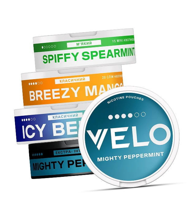На зображенні зображенні баночки VELO, а саме Spiffy Spearmint, Breezy Mango, Icy Berries, Mighty Peppermint
